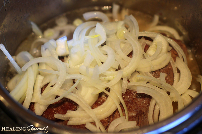 Image of onions and broth to the pressure cooker pot roast 